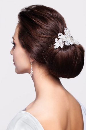 Portrait of beautiful young brunette woman from back side with knot of hair